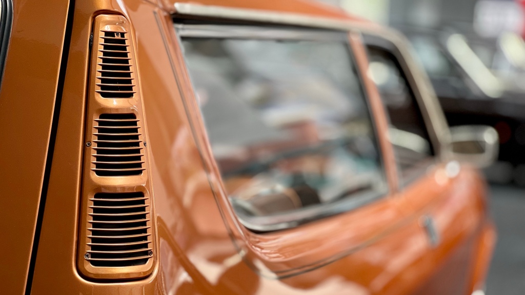 Detail of the long rear side window air extraction vent of a bronze Austin Allegro Estate