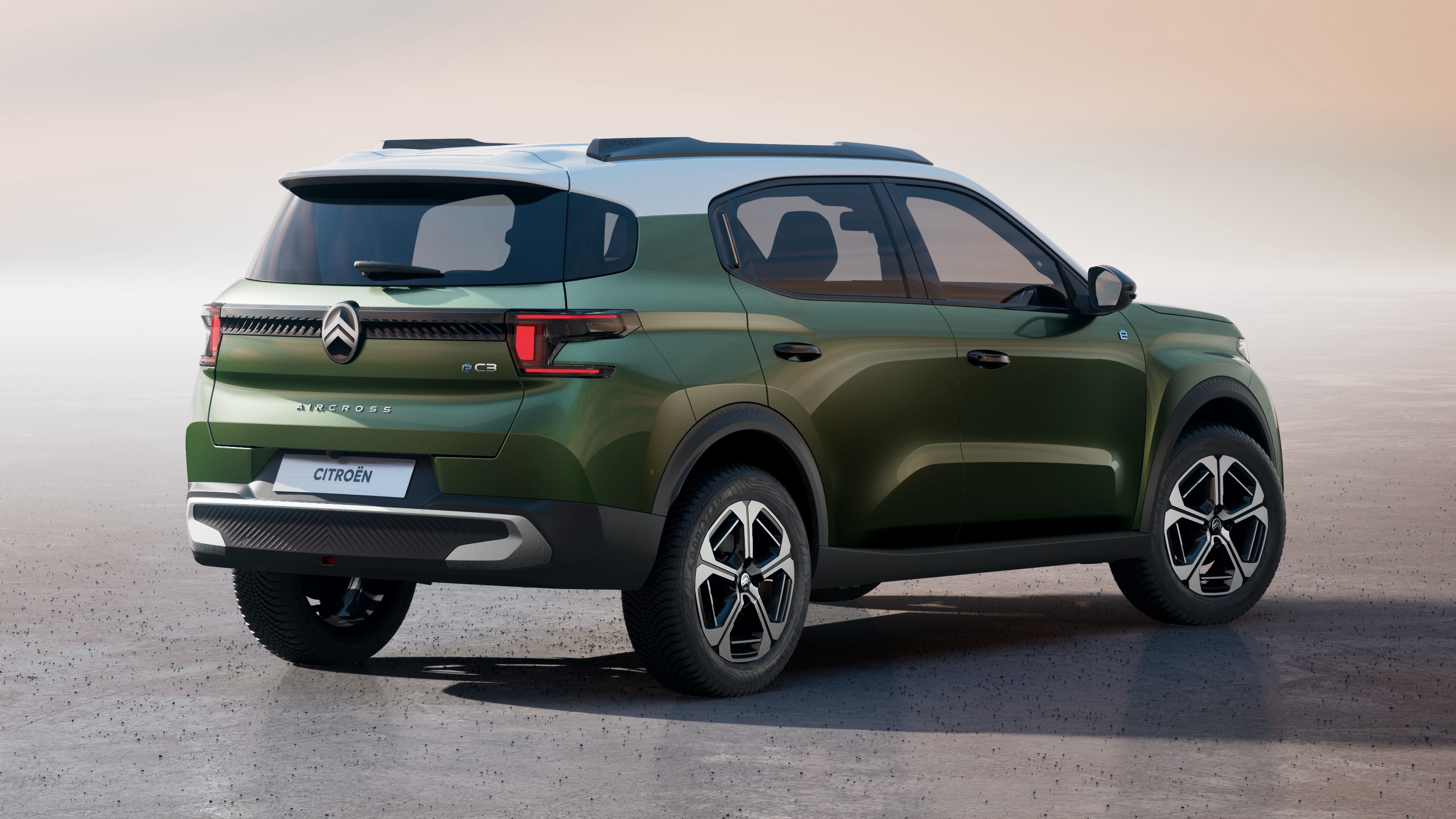 Rear three-quarters of a green and white Citroën ë-C3 Aircross