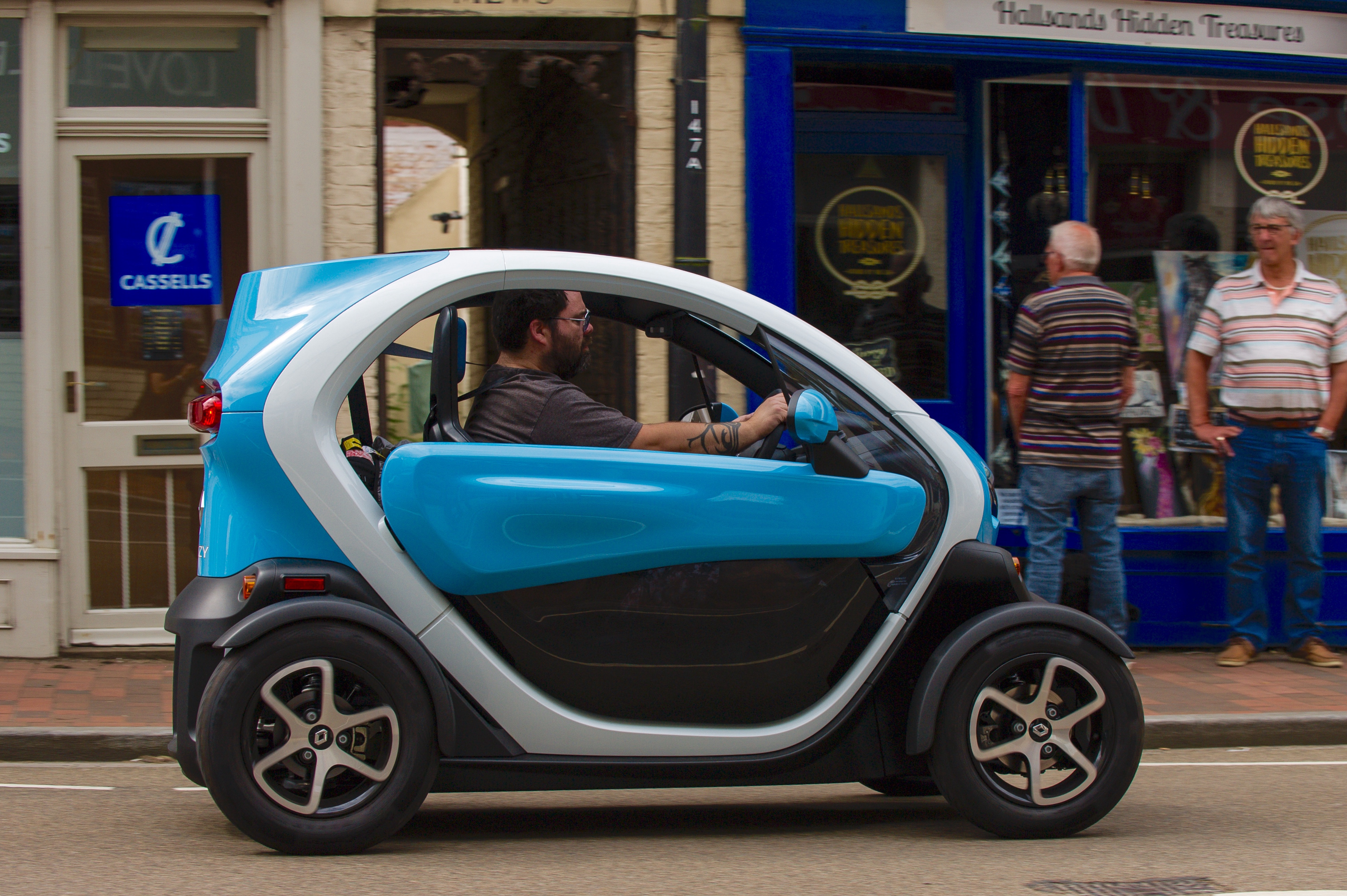 Side view of Keith WR Jones driving a blue and white Renault Twizy
