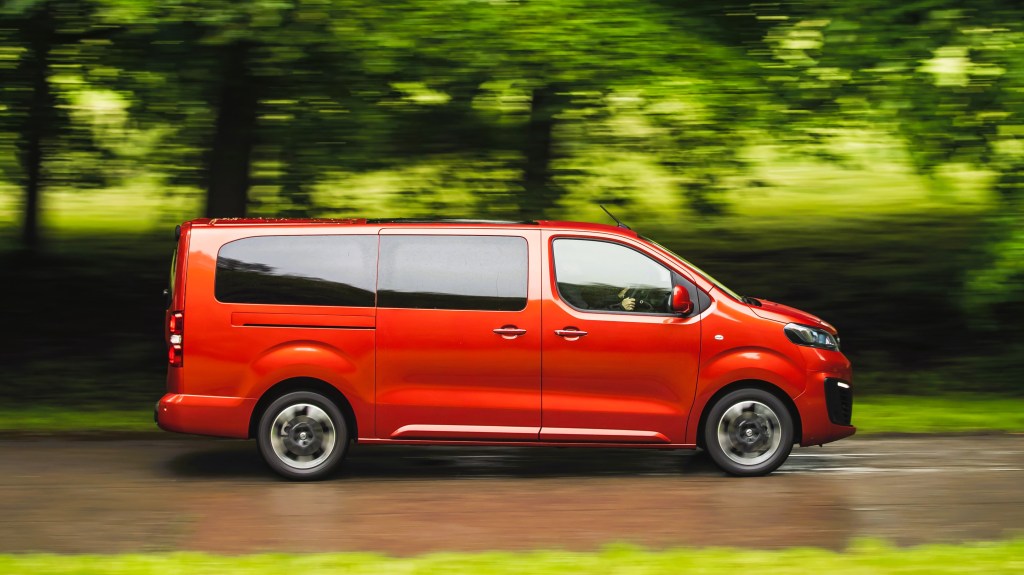 Side elevation of an orange Vauxhall Vivaro Life Elite